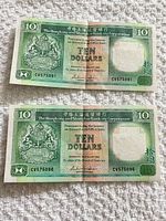 Fronts of both $10 notes showing serial numbers CV575091 and CV575096