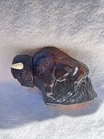 Right side of amber glass buffalo decanter showing horn and body detail
