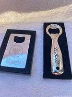 Carlsberg credit-card opener and Labatt handheld opener in boxes