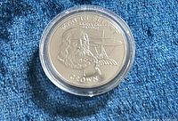 Reverse side of Isle of Man 1 Crown coin showing Leonardo da Vinci Man in Flight design in capsule