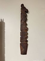Full view of carved wooden wall totem front