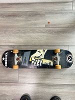 Full view of skateboard top to bottom on floor