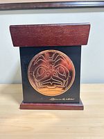 Front view showing copper medallion and artist signature