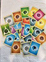 Pile of assorted Pokémon Energy cards showing multiple energy types