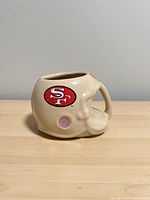 Left side view of helmet-shaped mug with 49ers logo