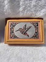 Top view showing hummingbird motif and wood frame