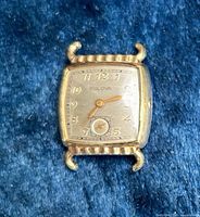 Front view of Bulova wristwatch showing dial and missing crown