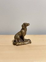 Left side view of brass hunting dog figurine