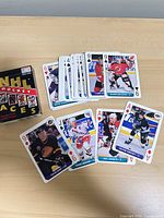 Deck spread displaying assorted player face cards and pips, box at side
