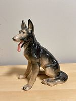 Front angled view of glazed porcelain German Shepherd figurine