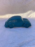 Left side view of teal Volkswagen Bug decanter showing molded details