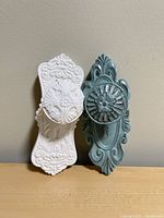 Front view of both wall hooks showing colors and ornate design