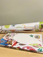 Rolled growth-chart decal and Paw Patrol package on tabletop
