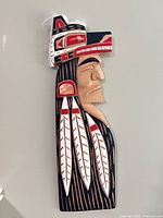 Full view of signed 24 in wooden Wolf Chief carving