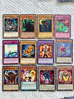 All 12 Yu-Gi-Oh cards laid out in three rows