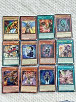Overall shot of 12 Yu-Gi-Oh! cards laid out 4×3 on surface