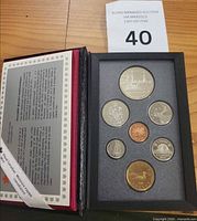 Open proof set showing all seven coins in holder with information card