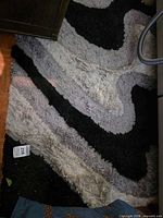 Overall view of rug showing abstract pattern and color palette