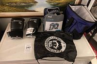 Group shot of mitts, gloves, drawstring bag and insulated tote