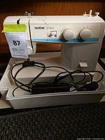 Full view of Brother LS-1217 sewing machine in tray with foot pedal