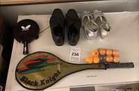 Overview of all items: racquet, paddle in case, balls, two pairs of shoes