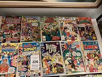 Group shot of all twelve comic books displayed on shelf