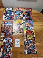 Group shot of eight Captain America comics on table