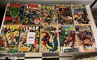 Ten bagged Marvel comics laid out, showing Thor and Spider-Man titles