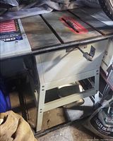 Full view of Delta QT-10 table saw on stand and mobile base