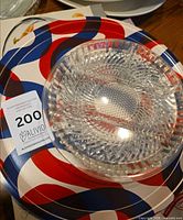 Round Luigi Bormioli tray with diamond pattern on box