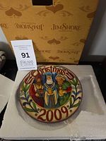 Front of plate showing Three Wise Men, Christmas 2009 inscription, box in background