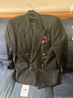Full view of black double-breasted blazer on hanger