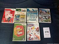 Front view of six Wii game cases on couch