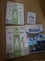 Front view of two Wii Fit Plus cases and one Wii Sports Resort case