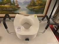 Raised toilet seat with handles, full view