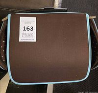 Front of brown fabric rolling tote with auction sticker visible