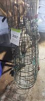 Stacked green wire tomato cages