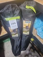 Two River Trail armchairs in black carry bags standing upright