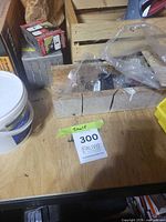 Tabletop with buckets, boxes of screws, nails, plastic bags of fasteners