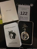 Pocket watch, tin, outer sleeve and paperwork overview