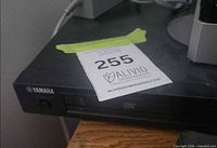 Front and top view of Yamaha DVD player showing brand logo, disc tray and control panel