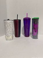 Front view of all four tumblers standing side by side