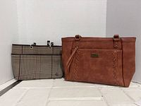 Brown faux leather tote and plaid pouch side by side