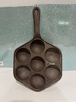 Front view showing hexagonal cast iron pan with seven wells