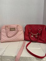 Front view of both Juicy Couture handbags