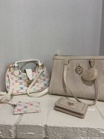 Both bags, wallet and card holder grouped together