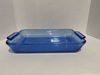 Side profile of blue glass baking dish showing overall shape and handles