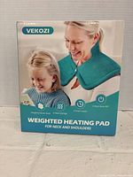 Front of boxed Vekozi weighted heating pad