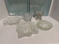 All five pressed glass pieces displayed