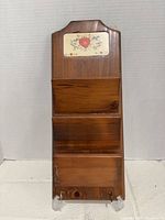 Full view of wooden mail holder showing three compartments and ceramic tile accent